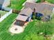 Aerial view of a backyard featuring a patio, a fire pit, green grass, a deck, and a privacy fence at 3530 Farm Lake Sw Dr, Concord, NC 28027