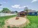 Spacious backyard with a circular fire pit, patio, and well-maintained lawn, ideal for relaxation at 3530 Farm Lake Sw Dr, Concord, NC 28027