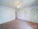 Bedroom featuring carpeted floors, a ceiling fan, a closet, and a bright, neutral color scheme at 3530 Farm Lake Sw Dr, Concord, NC 28027