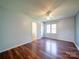 Bedroom featuring hardwood floors, updated ceiling fan, and natural light at 3530 Farm Lake Sw Dr, Concord, NC 28027