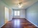 Bedroom featuring hardwood floors, updated ceiling fan, and natural light at 3530 Farm Lake Sw Dr, Concord, NC 28027