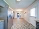 Open-concept kitchen and dining area featuring stainless steel appliances and contemporary flooring at 3530 Farm Lake Sw Dr, Concord, NC 28027
