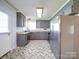 Spacious kitchen with stainless steel appliances, gray cabinetry, and stylish patterned flooring at 3530 Farm Lake Sw Dr, Concord, NC 28027