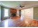 An open-concept living room features hardwood floors and a brick fireplace at 3530 Farm Lake Sw Dr, Concord, NC 28027