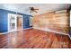 Bright living room featuring wood floors, natural wood accent wall and mini-split air conditioning at 3530 Farm Lake Sw Dr, Concord, NC 28027