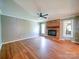 Hardwood floor living room featuring a brick fireplace, natural light and neutral wall colors at 3530 Farm Lake Sw Dr, Concord, NC 28027