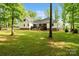 Expansive backyard with lush greenery and a beautiful view of the home's exterior at 358 Grassy Ridge Ct, Clover, SC 29710
