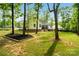 Secluded backyard showcasing a meticulously landscaped lawn and charming exterior of the house at 358 Grassy Ridge Ct, Clover, SC 29710