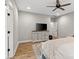 Bedroom with wood-look flooring, ceiling fan, and neutral decor, and a dresser with drawers and flatscreen TV at 358 Grassy Ridge Ct, Clover, SC 29710