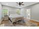 Serene bedroom with a decorative bed frame, ample natural light, and an ensuite bathroom with a soaking tub at 358 Grassy Ridge Ct, Clover, SC 29710