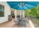 Elegant covered deck with an umbrella and seating for outdoor dining and relaxation at 358 Grassy Ridge Ct, Clover, SC 29710