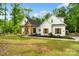 Beautiful white farmhouse-style home with a inviting front porch and lush, green lawn at 358 Grassy Ridge Ct, Clover, SC 29710