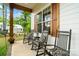 Detailed view of the front porch with rocking chairs, wooden accents, and green surroundings at 358 Grassy Ridge Ct, Clover, SC 29710