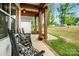 Inviting front porch with rocking chairs, flowers, and wooden pillars create a welcoming space at 358 Grassy Ridge Ct, Clover, SC 29710
