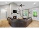 Inviting living room features a fireplace, large sofa, ceiling fan, and access to the outdoors at 358 Grassy Ridge Ct, Clover, SC 29710