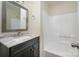 Clean bathroom showcasing vanity with marble countertop, faucet, mirror, towel rings, and a shower at 3625 Colony Crossing Dr, Charlotte, NC 28226