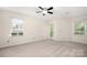 Bright bedroom featuring neutral walls, carpet, windows, and a door leading to a patio at 3625 Colony Crossing Dr, Charlotte, NC 28226