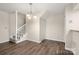 Dining area with neutral walls, a staircase, and laminate flooring at 3625 Colony Crossing Dr, Charlotte, NC 28226