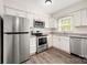 Well-lit kitchen with stainless steel appliances and white cabinetry provides a modern and functional space at 3625 Colony Crossing Dr, Charlotte, NC 28226