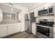 Kitchen with stainless steel appliances, granite countertops, and white cabinets offers a sleek and functional space at 3625 Colony Crossing Dr, Charlotte, NC 28226