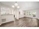 Spacious living room showcasing hardwood floors, seamlessly connecting the kitchen, dining, and entry areas at 3625 Colony Crossing Dr, Charlotte, NC 28226