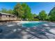 Inviting community pool surrounded by mature trees and a sun-drenched deck at 3625 Colony Crossing Dr, Charlotte, NC 28226