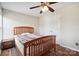 A neat bedroom boasts a wooden bed frame, bedside table, and a closet at 3849 Carl Parmer Dr, Harrisburg, NC 28075
