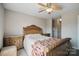 Comfortable bedroom with side tables, neutral tones, and ceiling fan at 3849 Carl Parmer Dr, Harrisburg, NC 28075