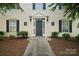 Charming building entrance with a well-lit doorway and manicured shrubbery at 3849 Carl Parmer Dr, Harrisburg, NC 28075