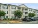 Inviting multi-story condo with white siding, dark shutters, and well-maintained landscaping at 3849 Carl Parmer Dr, Harrisburg, NC 28075