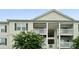 Close-up of a multi-story condo with white siding and spacious, private balconies at 3849 Carl Parmer Dr, Harrisburg, NC 28075