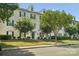 A three-story apartment building with blue shutters, landscaping, and paved sidewalks under a bright blue sky at 3849 Carl Parmer Dr, Harrisburg, NC 28075