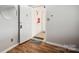 Bright, minimalist foyer with wood-look floors, a white door, and neutral walls at 3849 Carl Parmer Dr, Harrisburg, NC 28075