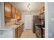 Well-lit kitchen featuring wood cabinets, stainless steel appliances, and stone countertops at 3849 Carl Parmer Dr, Harrisburg, NC 28075