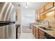 Well-lit kitchen featuring wood cabinets, stainless steel appliances, and stone countertops at 3849 Carl Parmer Dr, Harrisburg, NC 28075