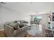 Spacious living room with hardwood floors, two sofas, and large windows at 3849 Carl Parmer Dr, Harrisburg, NC 28075