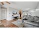 A comfy living room shows modern sofas, glass table, tv on the wall, and a view to the kitchen at 3849 Carl Parmer Dr, Harrisburg, NC 28075