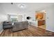 Open-concept living room and kitchen with wood floors and neutral color palette at 3849 Carl Parmer Dr, Harrisburg, NC 28075