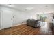 Cozy living room area with wood flooring, leading to a balcony and dining space at 3849 Carl Parmer Dr, Harrisburg, NC 28075