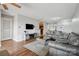 A comfy living room shows modern sofas, glass table, tv on the wall, and a view to the kitchen at 3849 Carl Parmer Dr, Harrisburg, NC 28075