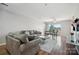 Spacious living room with hardwood floors, two sofas, and large windows at 3849 Carl Parmer Dr, Harrisburg, NC 28075