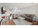 A spacious living room features hardwood floors and modern gray sofas with a decorative glass table at 3849 Carl Parmer Dr, Harrisburg, NC 28075
