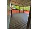 Covered deck offers an outdoor living area overlooking a wooded backyard with a red railing at 402 California St, York, SC 29745