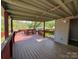 Enjoy backyard views from this spacious covered deck featuring a red railing at 402 California St, York, SC 29745