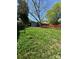 Large grass backyard with mature trees, providing shade, a deck and shed for outdoor entertaining at 402 California St, York, SC 29745
