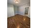 Cozy bedroom includes a closet, wood-look flooring and neutral paint at 402 California St, York, SC 29745