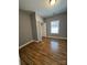 Bedroom has wood laminate floors, gray walls and a window bringing in natural light at 402 California St, York, SC 29745