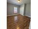 Cozy bedroom features laminate floors, a window, and a closet with a six-panel door at 402 California St, York, SC 29745