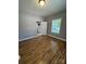 Bedroom featuring light gray walls, laminate flooring, a window with blinds, and base trim at 402 California St, York, SC 29745