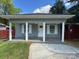 Charming home featuring a covered front porch with white columns and a freshly painted exterior at 402 California St, York, SC 29745